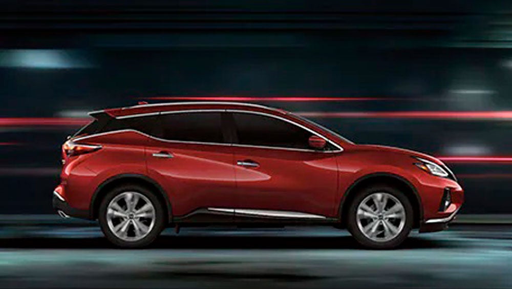 2023 Nissan Murano shown in profile driving down a street at night illustrating performance. | Nissan of Gilroy in Gilroy CA